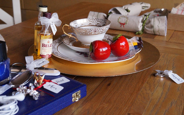 Assortment of plates, gifts and Christmas crackers on a table as photo props 