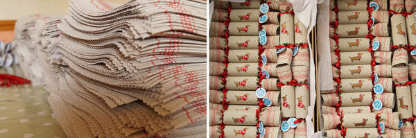 Stacks and boxes of fabric reusable Christmas crackers with dachshund motif by Kate Sproston Design