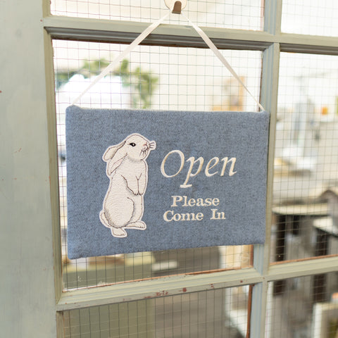 Embroidered open sign on the door of Kate Sproston Design studio