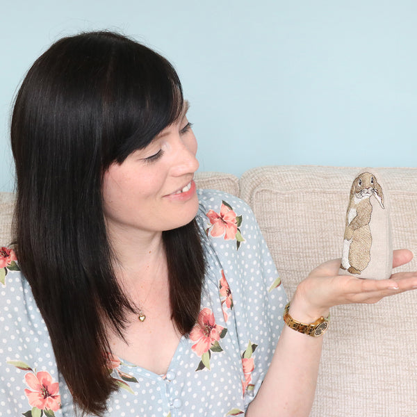 Kate Sproston with an embroidered rabbit egg cosy