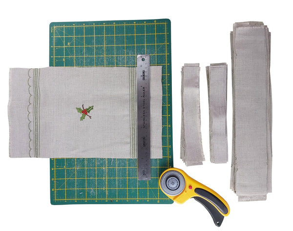 Cutting mat with rotary cutter and linen scraps