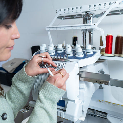 Kate threading up an embroidery machine