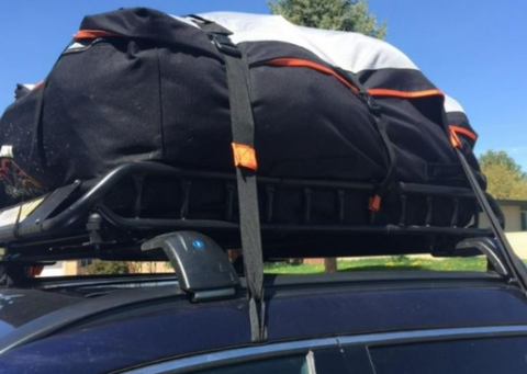 A roof rack strap ensures a load of camping gear stays secure, enabling a weekend escape to the great outdoors.