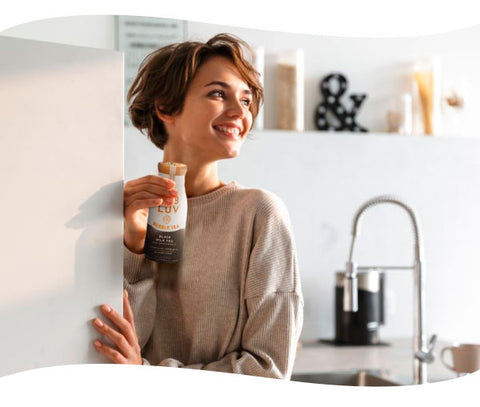 Girl pulling out a bottle of BUBLUV Bubble Tea from the fridge