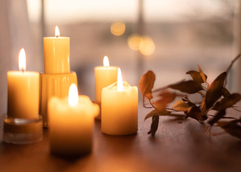 candles burning next to leaves
