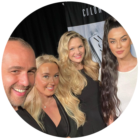 stylist giles robinson with three other women at a show