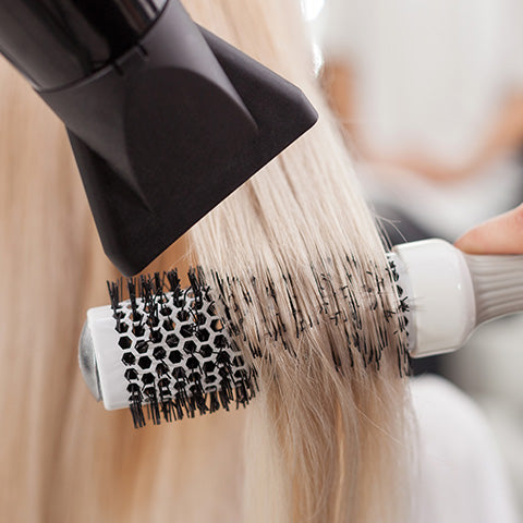 blonde hair strands being blow dried