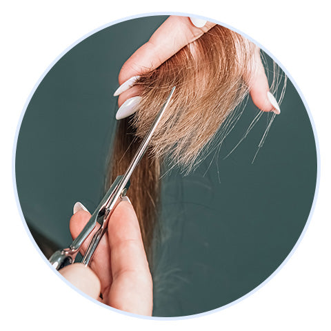 close-up of ends of hair being trimmed