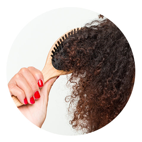 person brushing curly hair