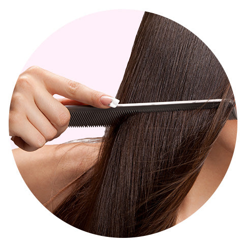 woman with brown hair having her hair combed