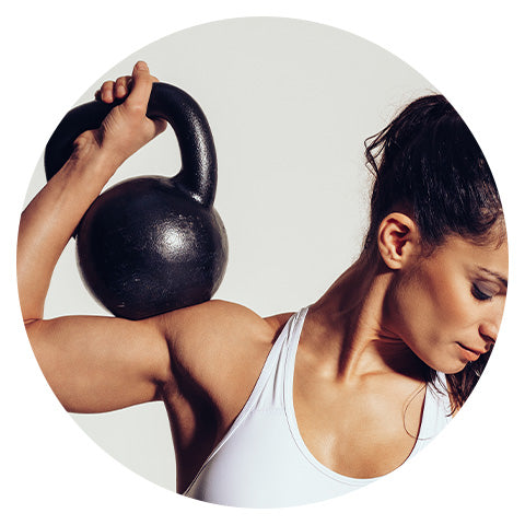 woman lifting a dumbbell onto her shoulder
