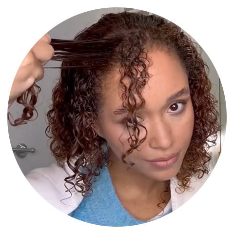 woman having her curls sectioned