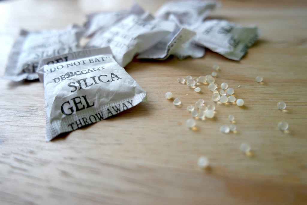Desiccants like silica gel beads actively absorb humidity to prevent moisture damage to filaments.