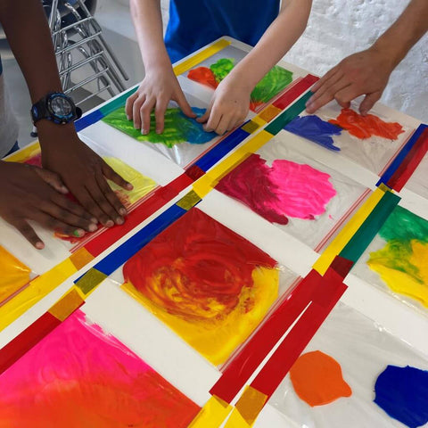 Children's hands make art inspired by museum work