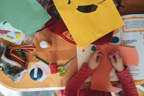 Child making art out of scrap materials