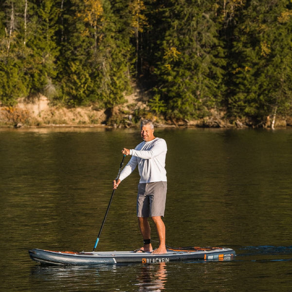 Man riding BLACKFIN standup paddle board