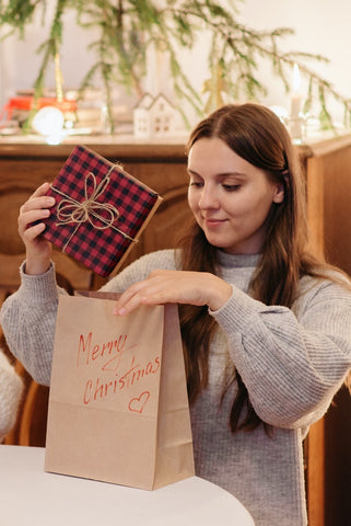 Girl placing gift into gift bag