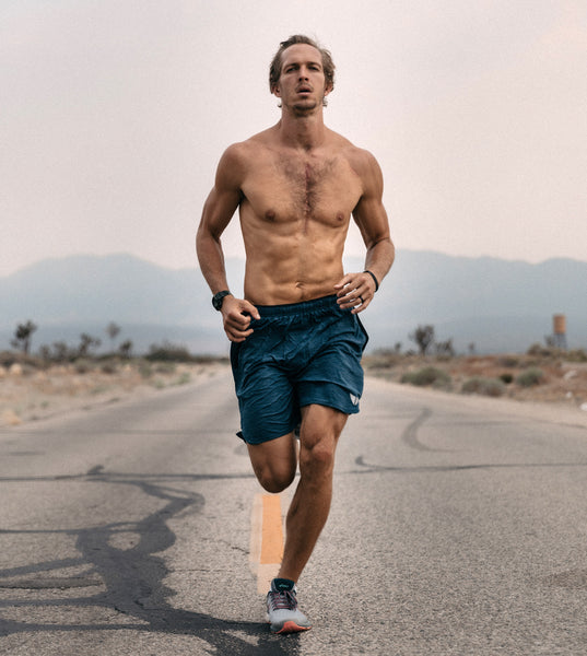 Shirtless man runs down street in summer heat