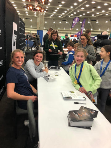 Charlotte North and Ally Mastroianni signing autographs at the Gait Lacrosse booth