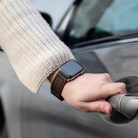 Buckle and Band Vegan leather Apple Watch strap being worn on a wrist, opening a car door