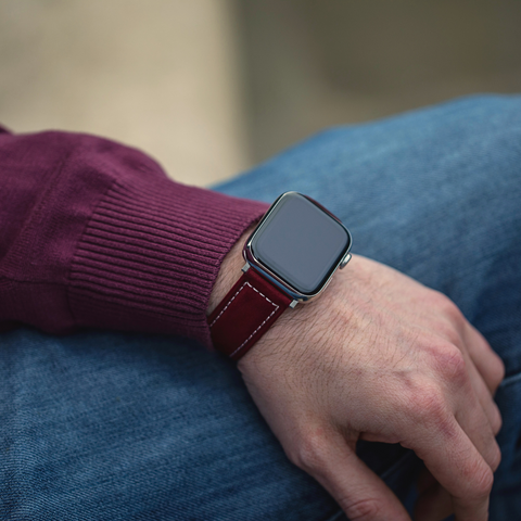 Mila red suede leather Apple Watch strap by Buckle and Band, being worn on the arm of someone wearing a red jumper