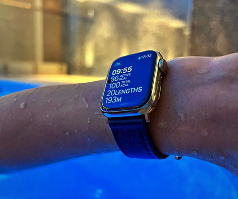 Apple Watch Series 7 being worn in a swimming pool, with exercise tracking