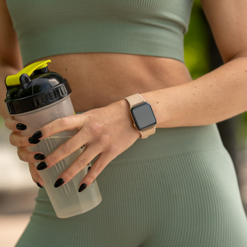 Mona pink workout strap by Buckle and Band being worn by a woman in gym attire during a run