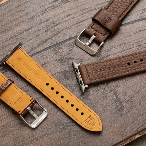 Buckle and Band luxury Apple Watch straps laid out on a table, showcasing the leather and materials