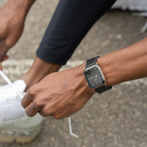 Buckle and Band Hybri black sports strap being worn on the wrist of someone out for a run. They're adjusting their shoelaces