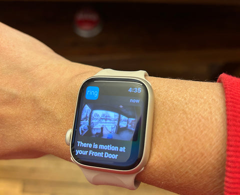 Apple Watch displaying a live camera feed of a front porch from a Ring doorbell camera. Notifying them that movement has been detected