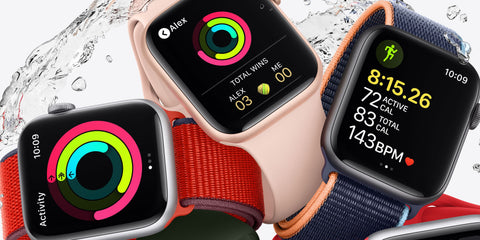 Different coloured Apple Watches displaying the activity rings feature