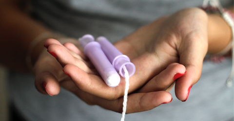 hands holding a tampon