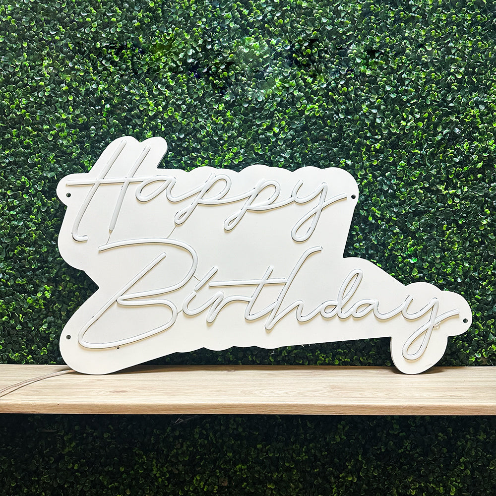 happy birthday neon sign in white with white backboard