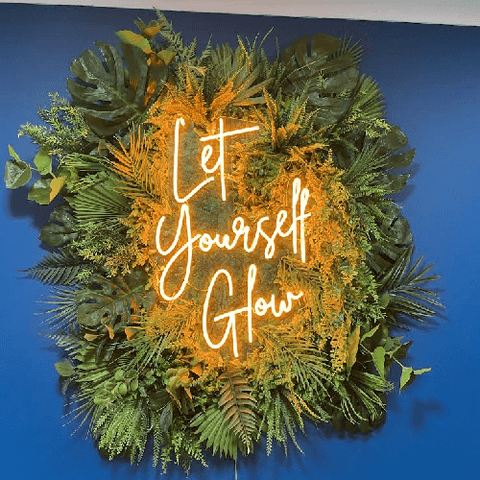 led neon sign with fake grass on the background