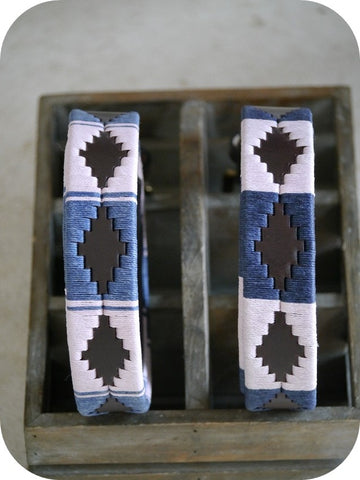 two pampeano polo belts in a wooden box