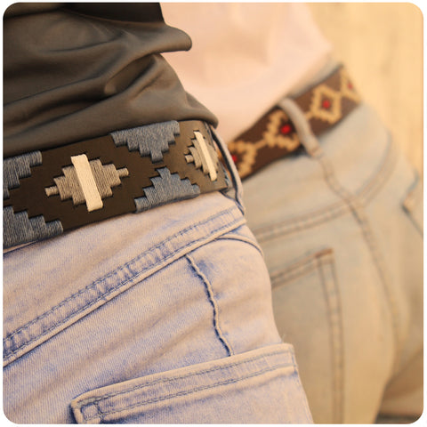 close-up of two people wearing belts