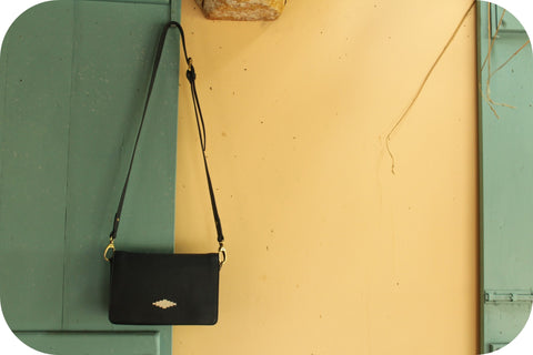 bag hanging by a blue door