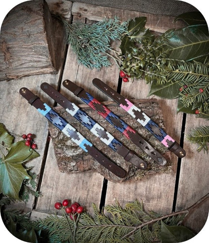 Polo bracelets on a log surrounded 