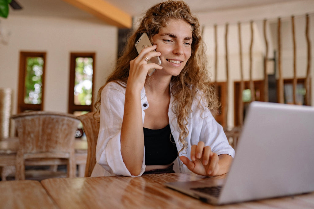 Woman on phone and laptop on a medical cannabis license call