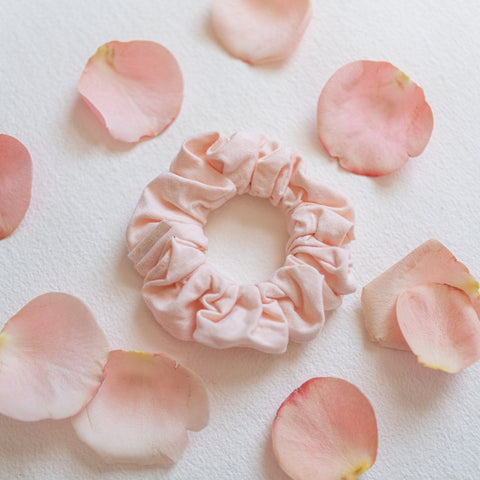 KOOSHOO plastic-free pale pink scrunchies surrounded by pink rose petals for valentines day