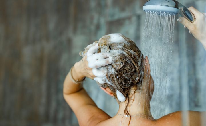 woman washing her hair in the shower