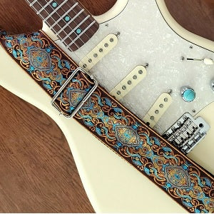 Pardo Guitar Strap model Orange Lacy hippie strap for guitar and bass with a white Fender Stratocaster