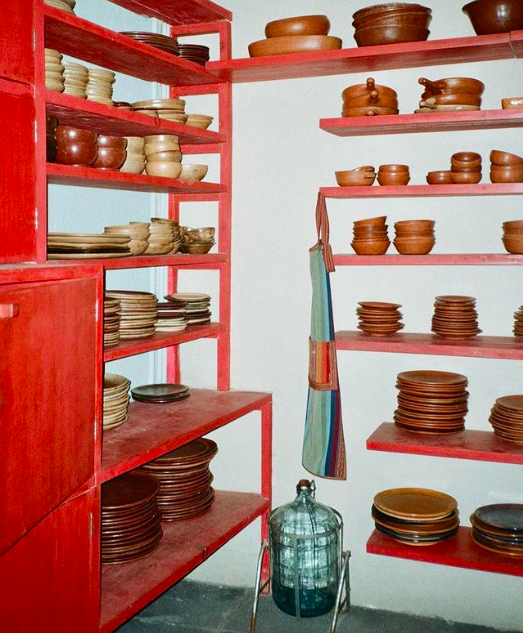 Jorum Studio Pentimento Visual Journey Casa Pedregal clay bowls stacked on red shelves