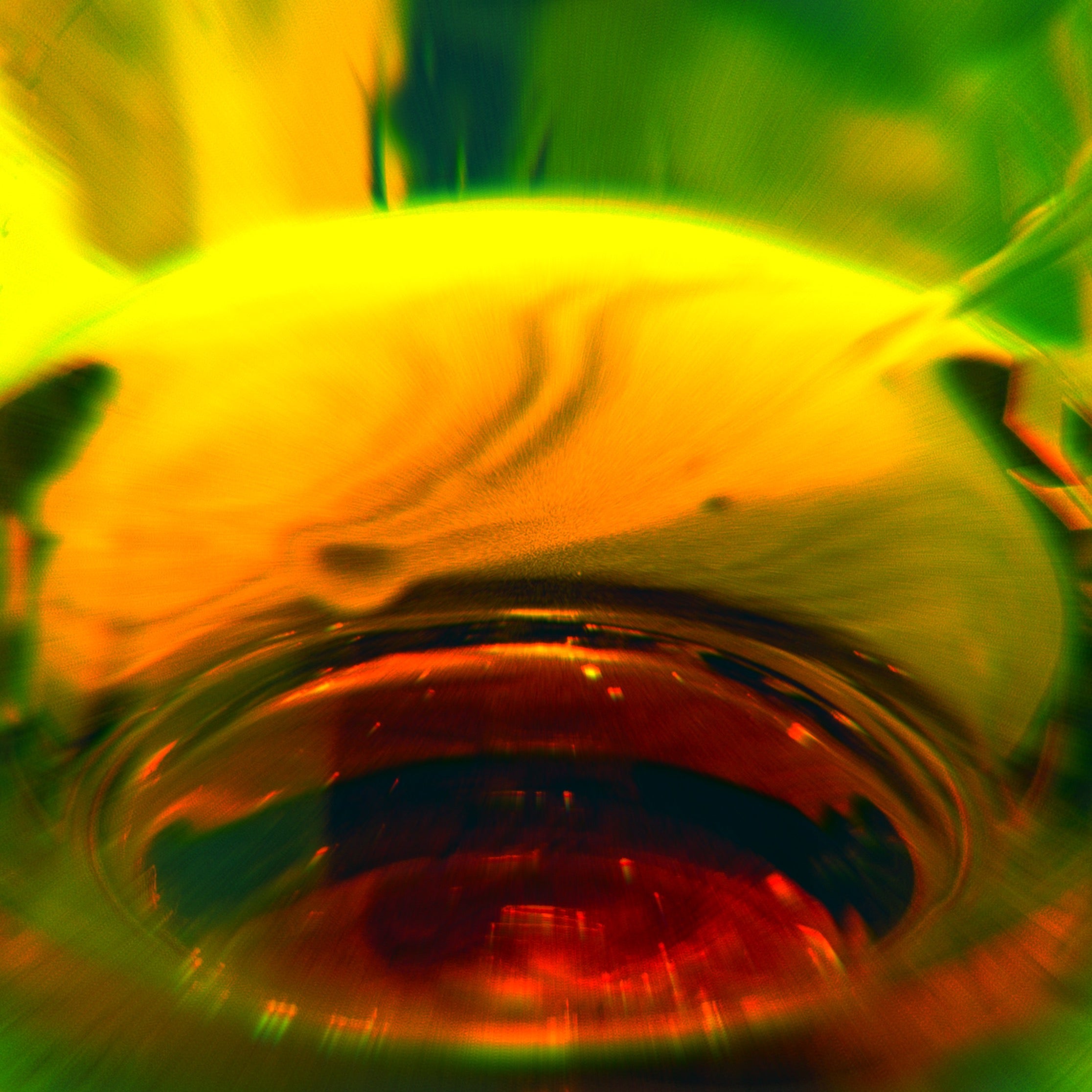 Abstract image of whisky dram in brown, yellow and green tones. Image by Jorum Studio.