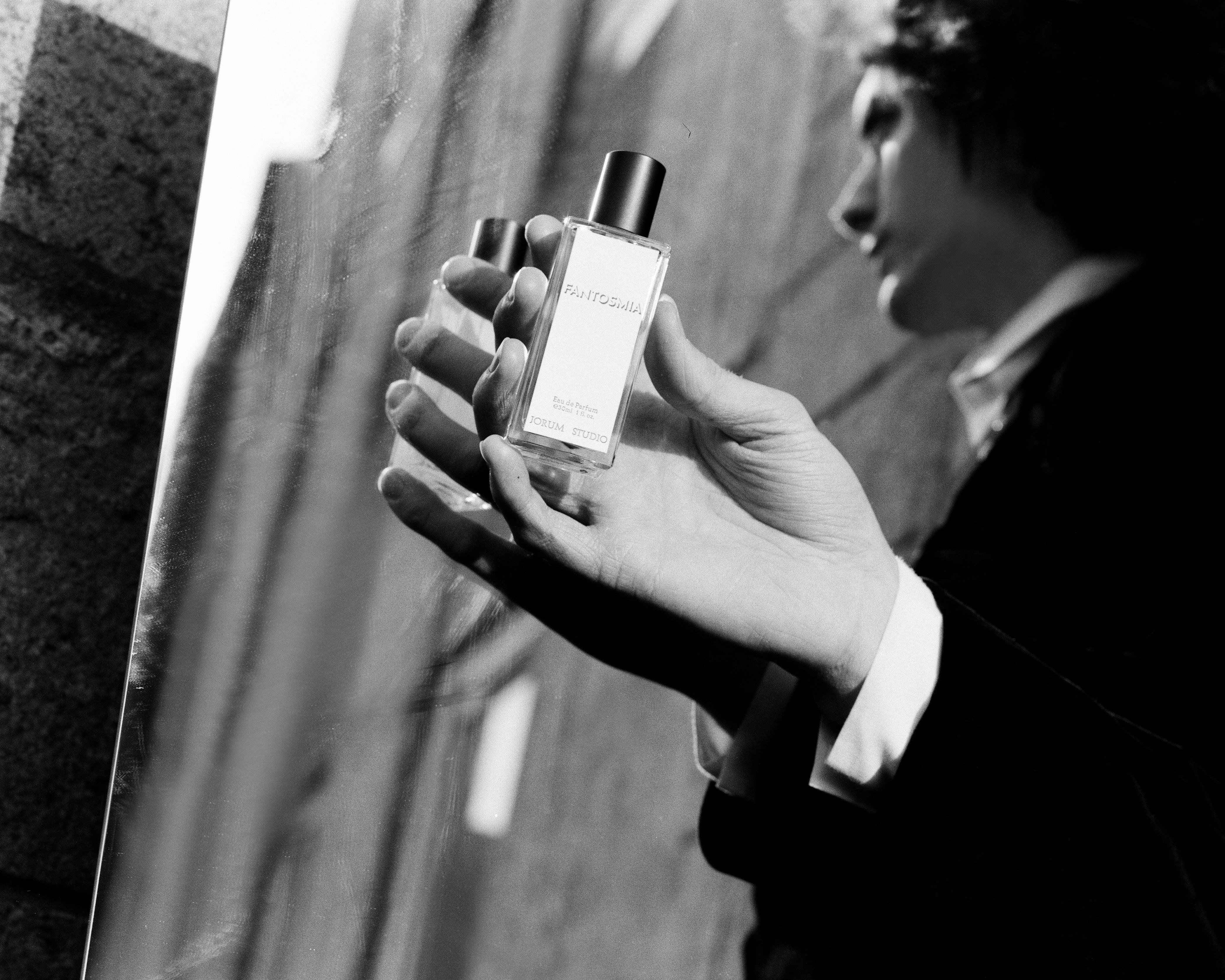 Jorum Studio Winter Campaign model's hand holding bottle of Fantosmia Eau de Parfum by Jorum Studio