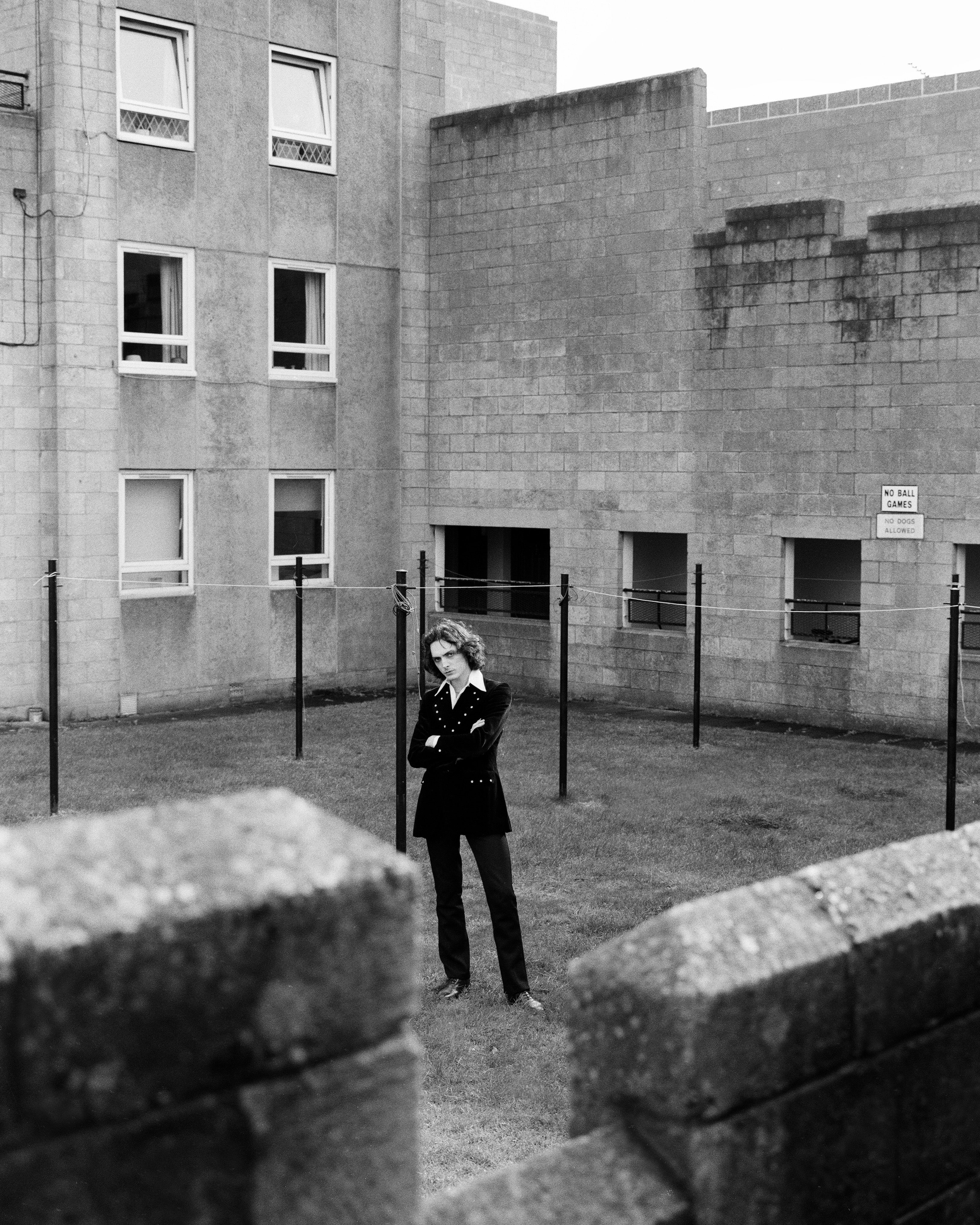 Jorum Studio Winter Campaign model standing in communal garden among washing lines