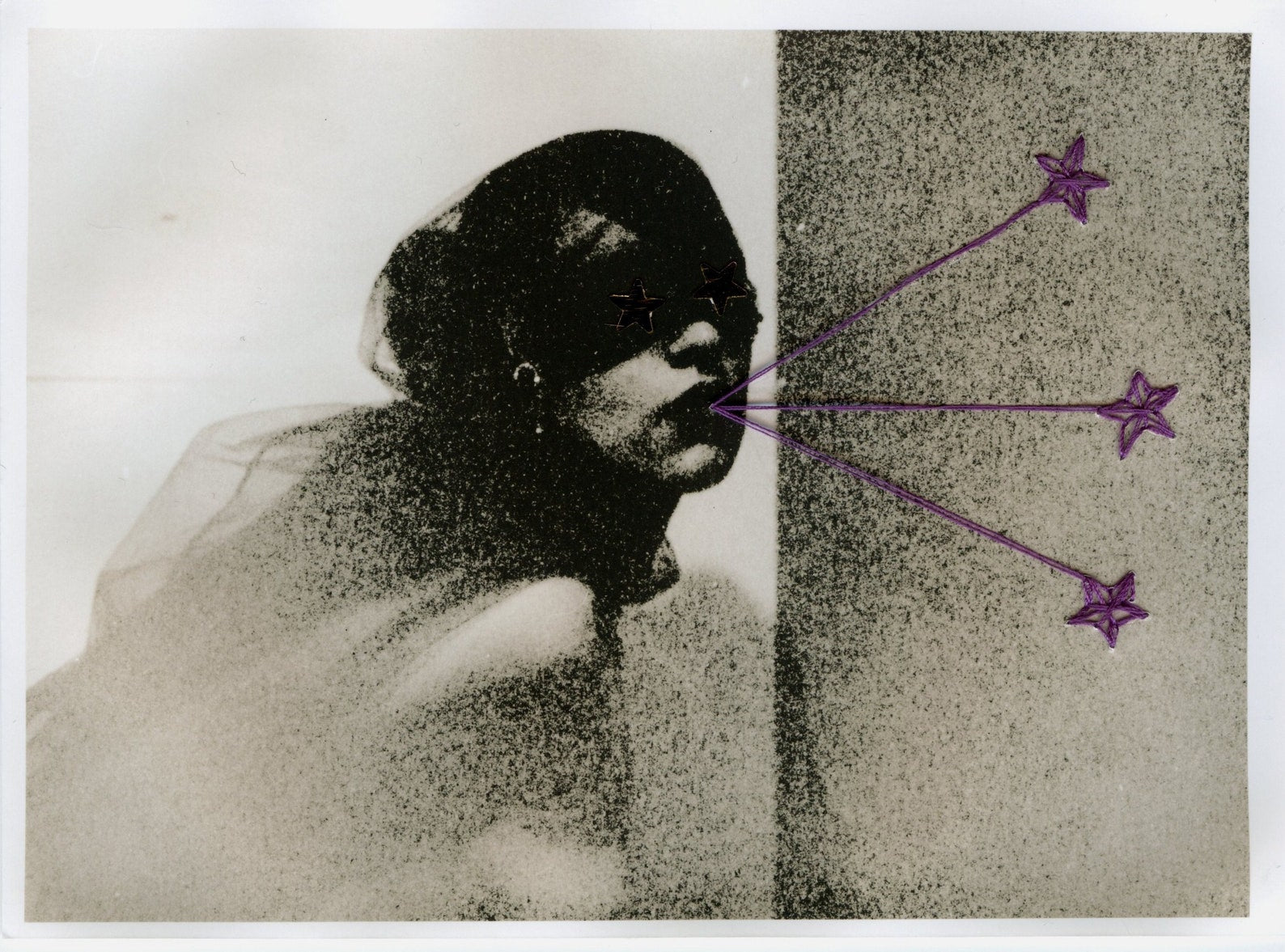 A black and white photographic print of a young woman with her eyes covered and three purple stars shooting from her mouth