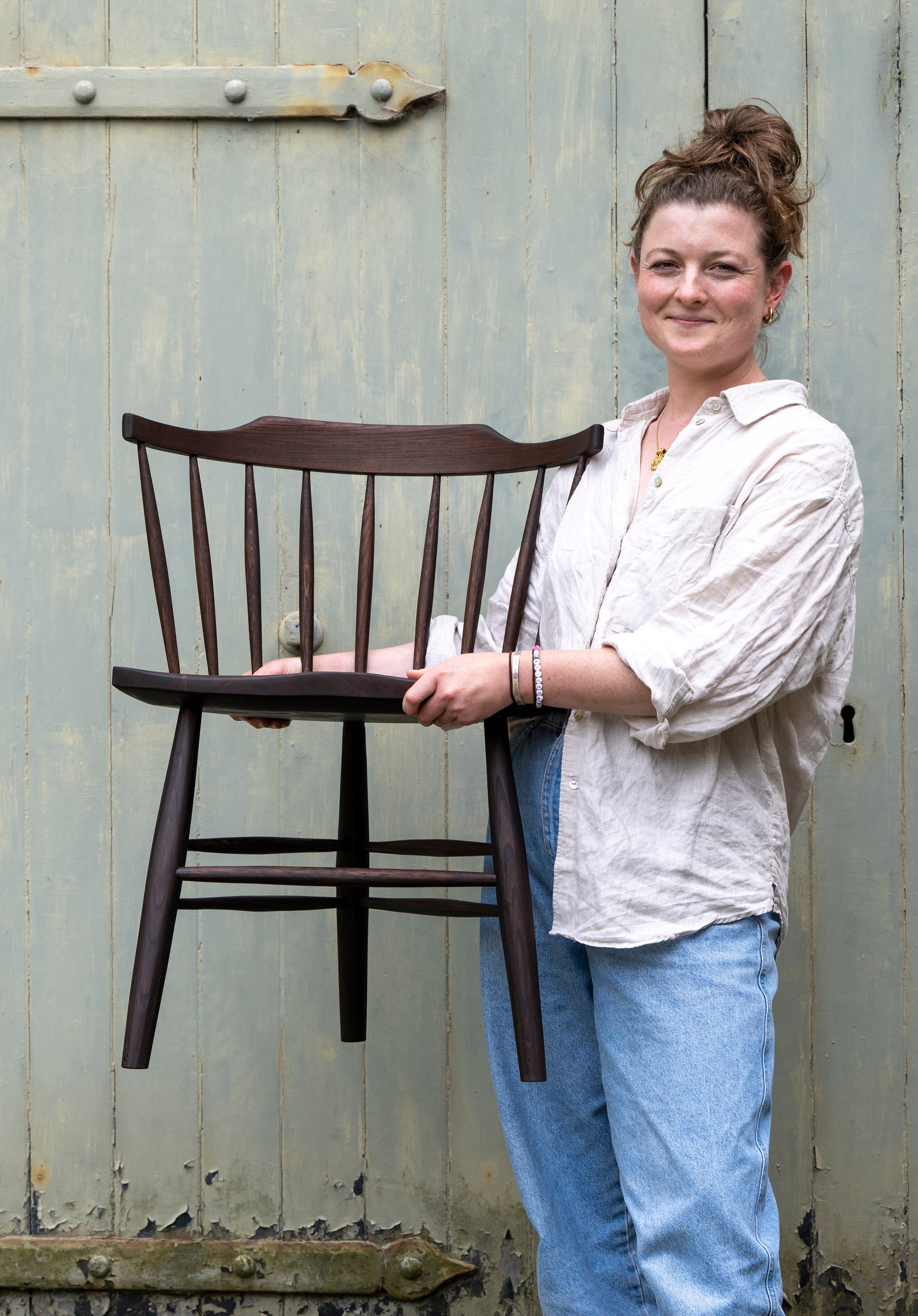 COMPASS: Emerging Maker Helena Robson holding chair