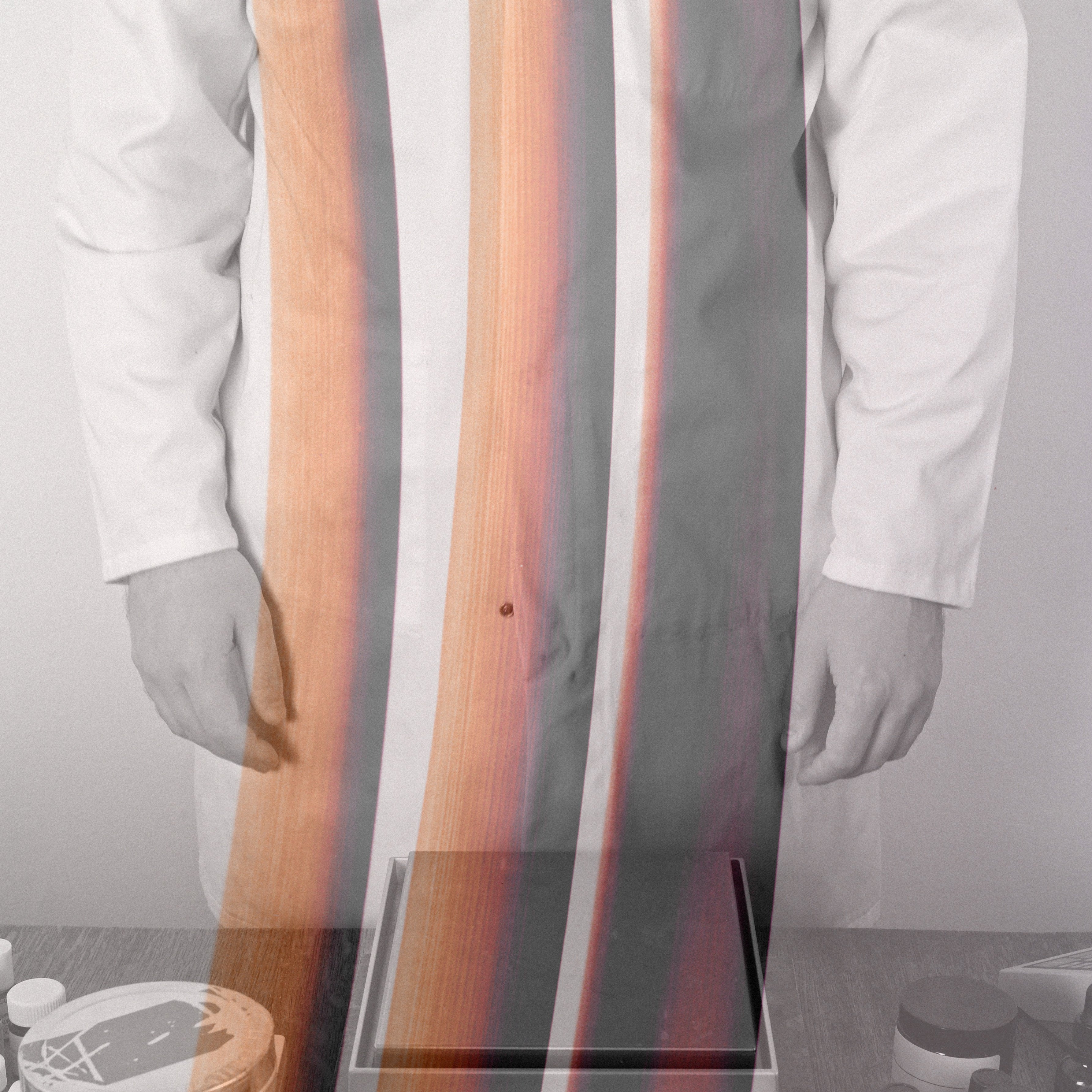 Perfumer in white lab coat overlaid with abstract image of rhubarb stalks