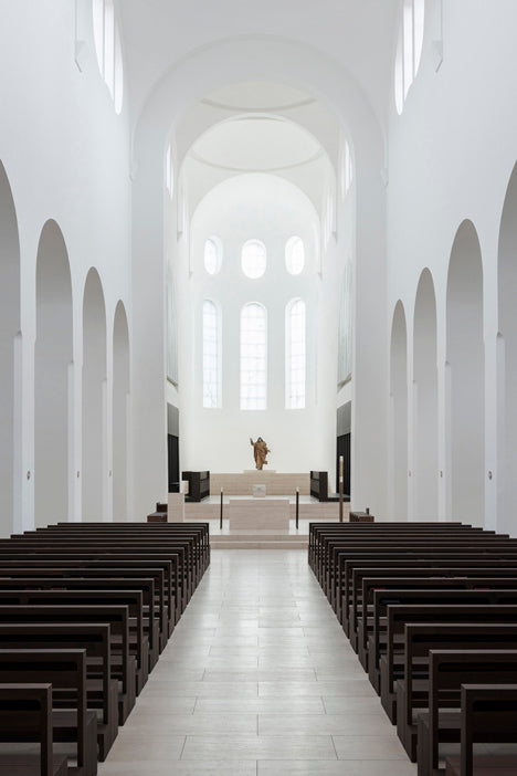 Photograph of serene and empty church with white walls and large windows: St Moritz Church by John Pawson